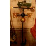 A modern cast metal weather vane with a Land Rover finial