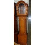 A reproduction polished pine longcase clock case with flanking bobbin quarter columns to trunk