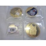 A selection of encapsulated and boxed gold plated commemorative coins