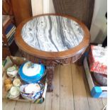 A 76cm diameter 20th Century Oriental carved hardwood tea table with grey marbled inset top and