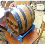 A vintage coopered oak barrel pattern drinks cabinet with baize lined interior and old polished