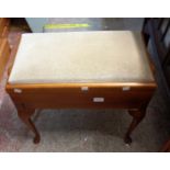 A modern stained wood adjustable locker piano stool with velour upholstered seat, set on cabriole