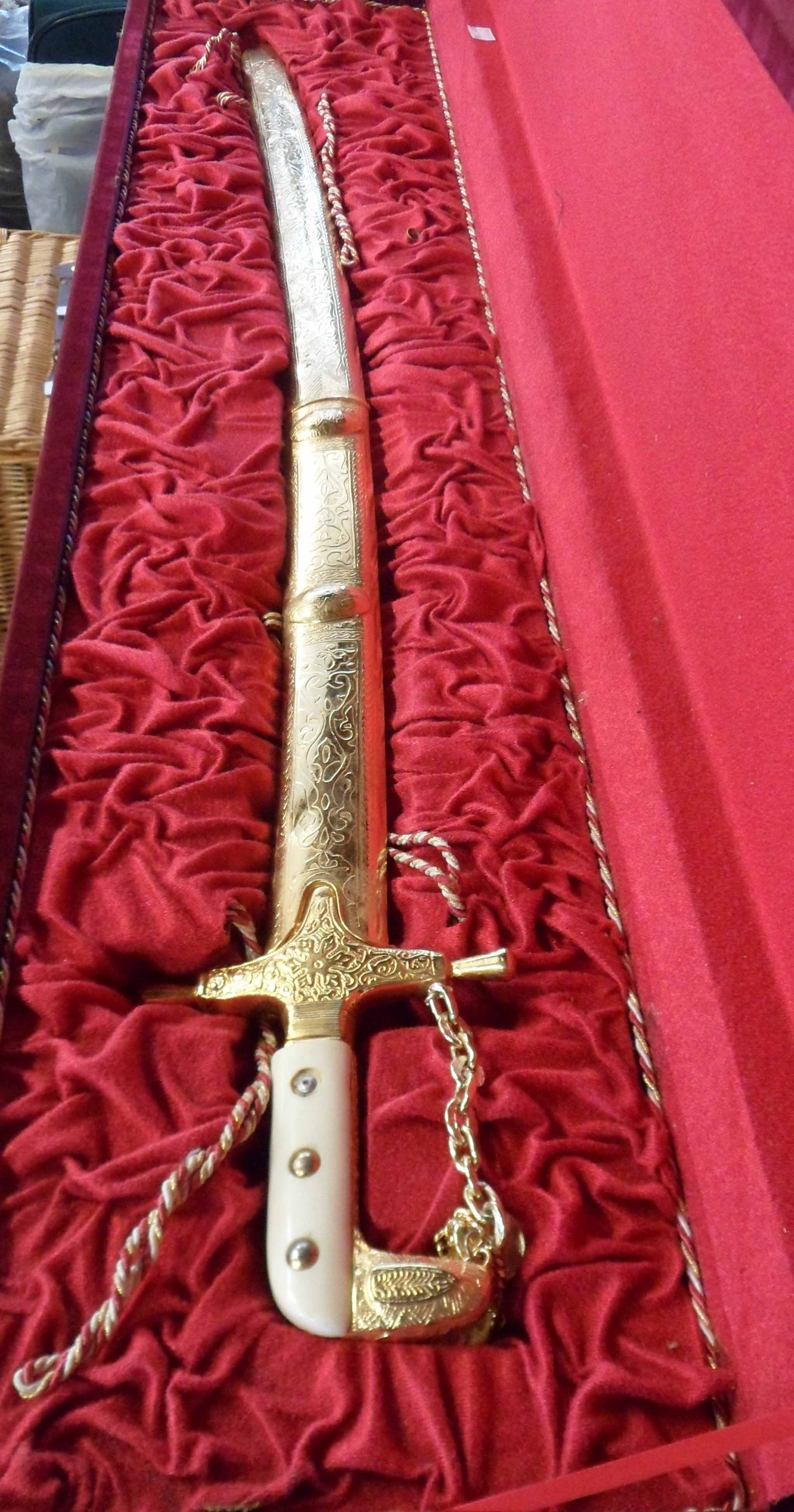 A boxed modern reproduction cavalry officer's sword with decorative scabbard