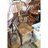Windsor elbow chair An antique Windsor elbow chair with slender curved central rail and solid elm
