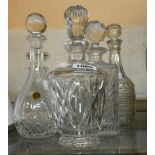 Four assorted cut and moulded glass decanters with stoppers