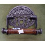 A reproduction cast metal and wood GWR toilet roll holder