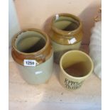 Two stoneware jars and a vintage tiki green kitchen themed utensil holder