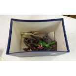 A box containing vintage lead figures and horses, etc.