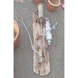 An antique farmhouse hand water pump on remains of mounting board