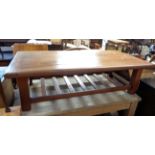 A 1.39m modern far eastern hardwood coffee table with slatted undertier, set on square supports