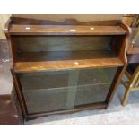 A 90cm retro oak bookcase with two open shelves and sliding glass doors under