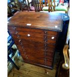 A 61cm Victorian stained wood chest with flight of eleven graduated drawers, set on plinth base -