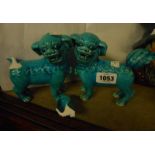 A pair of Chinese pottery turquoise glazed temple dogs - one with glued repair to tail