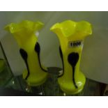 A pair of continental Art Nouveau yellow cased glass vases decorated with applied ribbon trail