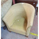 A modern wicker tub chair, set on square tapered legs