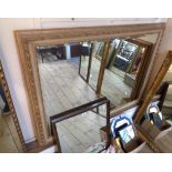 A 1.23m X 93cm modern parcel gilt framed bevelled oblong wall mirror with decorative border