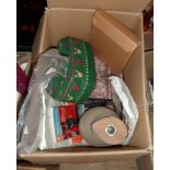 A box containing an assortment of vintage sewing and fashion items including milliner's hat block,