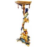 A 1.03m high old ornate painted and gilded pine Blackamoor torchiere, set on a dragon pattern pillar