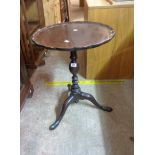 A 49cm diameter antique mahogany pedestal table, set on turned pillar and tripod base - minor damage