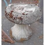 A concrete bird bath with top