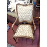 An Edwardian mahogany and strung show frame elbow chair with upholstered back and seat, set on