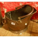 A copper helmet coal scuttle