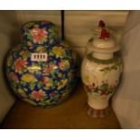 A pair of Chinese lidded vases decorated with figures in a Famille Rose palette (both a/f) - sold