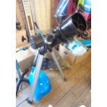 A Celestron Power Seeker 127EQ telescope on tripod stand with accessories