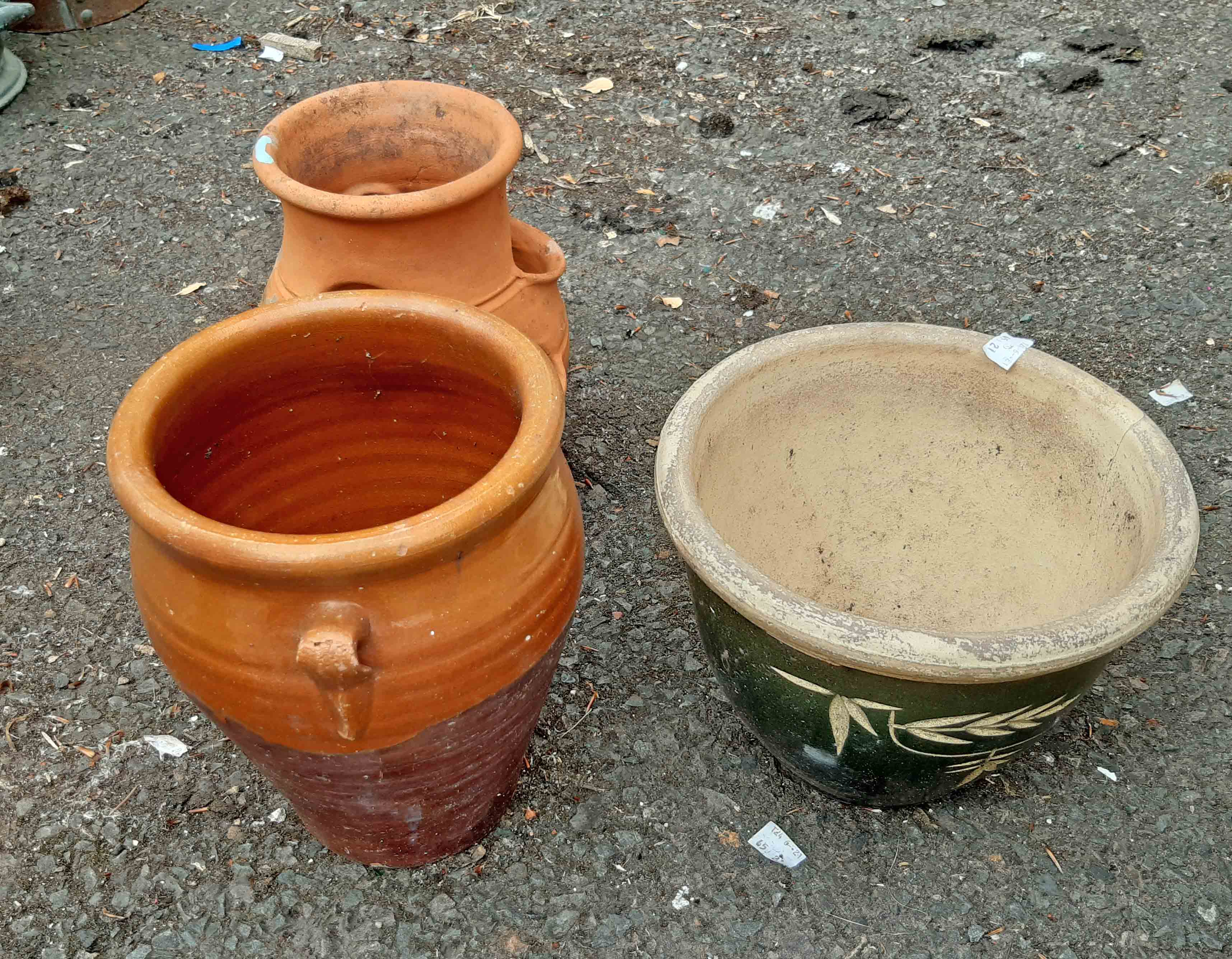 Two terracotta planters and a small terracotta strawberry pot