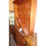 A 1.32m 20th Century pine and mixed wood five shelf open bookcase with double cupboard under, set on