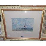 A gilt framed watercolour, depicting beached sailing boats - indistinctly monogrammed