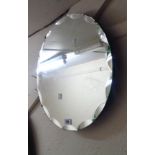 A 45cm diameter vintage frameless bevelled wall mirror with faceted border