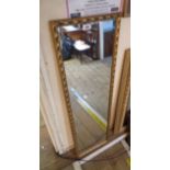 A gilt framed narrow oblong wall mirror