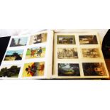 A blue album containing a collection of sleeve mounted mainly early 20th Century postcards,