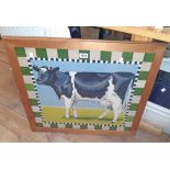 A framed large woolwork panel study of a Friesian cow, within a decorative border