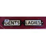 A pair of modern cast metal signs - ladies and gents
