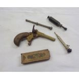 A small collection of items including old cap gun, boxed pick up tool, propelling pencils, etc.