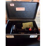 A 1950's Singer 221K Featherweight electric sewing machine with tray fitted case and accessories