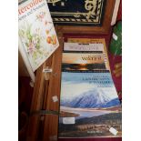 A wood easel and art books