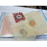 A ring bound folder containing a collection of 1920's and later tissue paper orange wrappers
