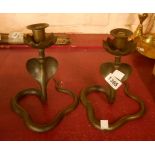 A pair of old Indian cast brass cobra candlesticks