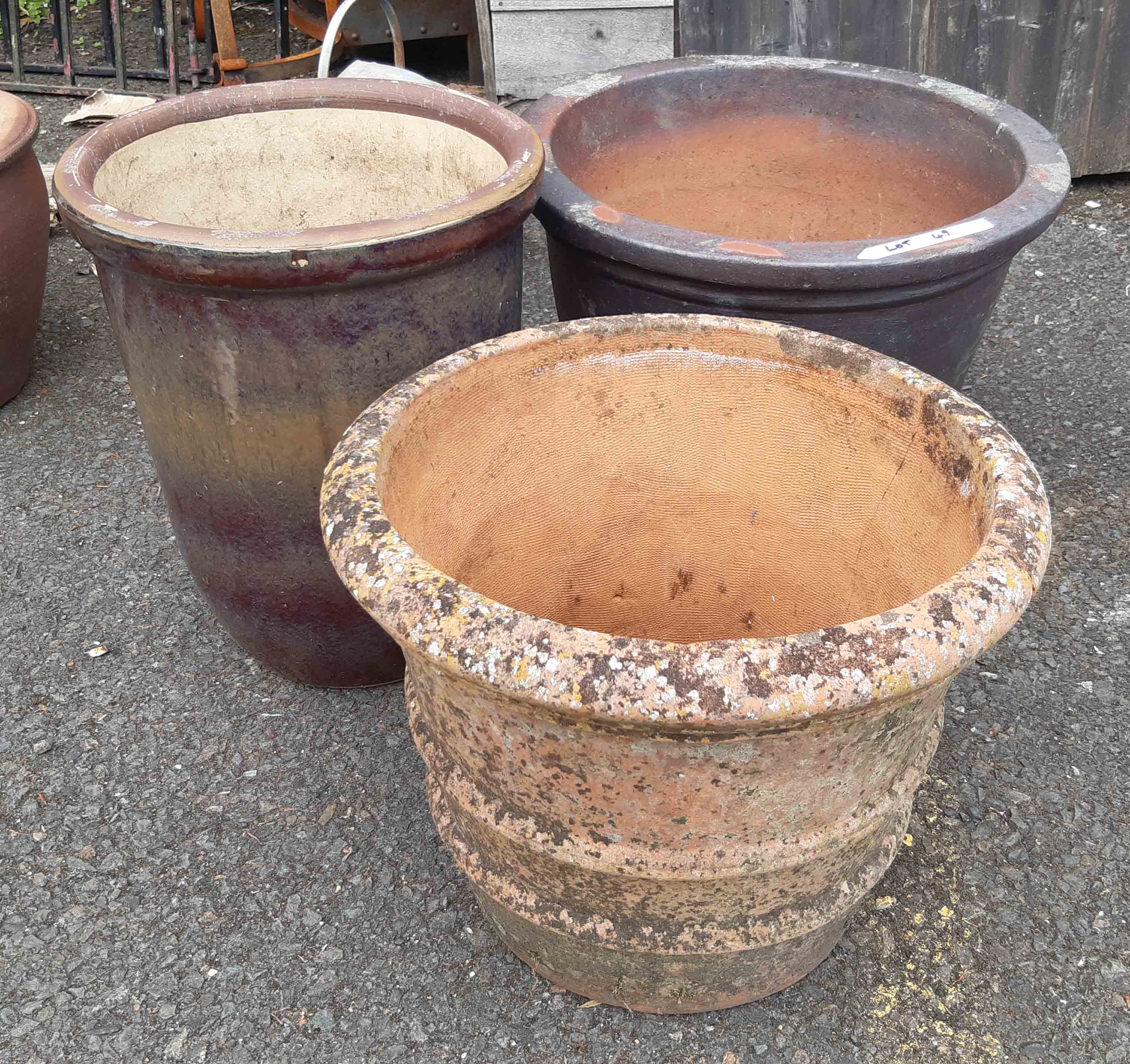 Three large garden planters, comprising one terracotta, one salt glazed stoneware and a stone