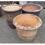Three large garden planters, comprising one terracotta, one salt glazed stoneware and a stone
