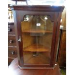 A 53cm modern mahogany effect wall hanging corner cabinet enclosed by a glazed panel door