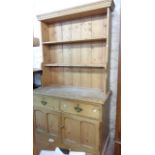 A 1.15cm old stripped pine two part dresser with two shelf open plate rack over a base with two