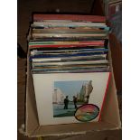 A box of LP and 45s records including Thin Lizzy, Eric Clapton, The Police, Pink Floyd, etc.