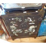 A 59cm 20th Century Chinese lacquered two door cabinet with gilt decoration and profuse applied