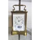 An old brass and bevelled glass cased carriage clock with eight day bell striking movement