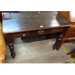 A 1.08m Edwardian stained walnut side table with short frieze drawer, set on turned legs