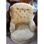 An antique drawing room armchair with remains of button back upholstery, set on square tapered front